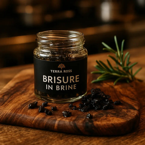 Jar of dark granular food preserved in brine from Terra Ross Black Summer Truffle Collection