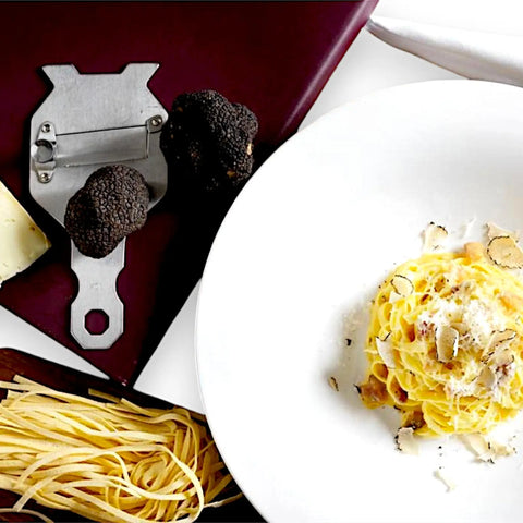 Silver truffle grater with black truffles and pasta from Terra Ross premium truffle products