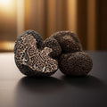 Close-up of truffles on a dark surface with a blurred background