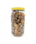 Dried morels Morchella Esculenta in a clear glass jar with yellow lid for gourmet cooking