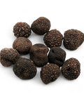 Pile of black black truffles from fresh autumn truffle Tuber Uncinatum B-grade
