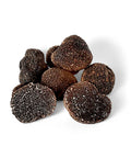 Dark textured black truffle pile of Tuber Melanosporum winter black truffles for gourmet cooking